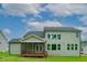 Back exterior features a screened porch and large windows overlooking a spacious backyard under a bright sky at Lot 1 Northpointe Farms Trl, Efland, NC 27243