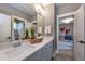 Bright bathroom with dual sinks, white countertops, and a view into a bedroom, offering a fresh design at Lot 1 Northpointe Farms Trl, Efland, NC 27243