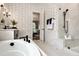 Bright primary bathroom with a soaking tub, walk-in shower, and attractive wallpaper at Lot 1 Northpointe Farms Trl, Efland, NC 27243