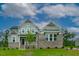 Charming two-story home with brick accents and a beautifully landscaped front yard on a sunny day at Lot 1 Northpointe Farms Trl, Efland, NC 27243