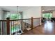 Hallway with railing overlooking staircase, hardwood floors, and a view to other rooms at Lot 1 Northpointe Farms Trl, Efland, NC 27243