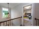 Upstairs hallway with railing overlooking staircase and a view to a bedroom at Lot 1 Northpointe Farms Trl, Efland, NC 27243