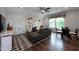 Inviting living room featuring a cozy sectional sofa, modern artwork, and ample natural light from the window at Lot 1 Northpointe Farms Trl, Efland, NC 27243