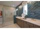 Modern bathroom featuring dual sinks, stylish blue tile, a glass-enclosed shower, and ample counter space at Lot 2 Northpointe Farms Trl, Efland, NC 27243