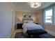 Comfortable bedroom featuring a queen bed, nightstands, lamps, an area rug and light pink wood paneling at Lot 2 Northpointe Farms Trl, Efland, NC 27243