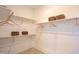 Walk-in closet with built-in shelves, wooden rods, ample storage space, and hardwood floors; clean and organized at Lot 2 Northpointe Farms Trl, Efland, NC 27243