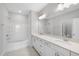Bright bathroom featuring double vanity with quartz counters and tub with shower combo at 100 Ripple Way # 317, Clayton, NC 27520