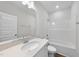 Bright bathroom with a single vanity, shower and bathtub combo, and wood-look flooring at 100 Ripple Way # 317, Clayton, NC 27520