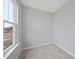 Cozy bedroom with a plush carpet, a light gray walls, and large window at 100 Ripple Way # 317, Clayton, NC 27520