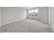 Carpeted bedroom with ample light from the three-pane window at 100 Ripple Way # 317, Clayton, NC 27520