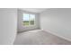 Bright bedroom with plush carpet and a large window showcasing a green outdoors at 100 Ripple Way # 317, Clayton, NC 27520