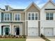 Charming townhome exteriors feature individual garages and tasteful modern color schemes at 100 Ripple Way # 317, Clayton, NC 27520