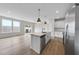 Open-concept floor plan showcasing the kitchen with island and stainless appliances at 100 Ripple Way # 317, Clayton, NC 27520
