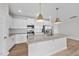Modern kitchen featuring white cabinets, stainless appliances, and a granite island at 100 Ripple Way # 317, Clayton, NC 27520