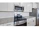 Close up of stainless appliances, subway tile backsplash and granite countertops at 100 Ripple Way # 317, Clayton, NC 27520