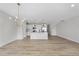 Bright and airy living space and kitchen with modern chandelier lighting at 100 Ripple Way # 317, Clayton, NC 27520