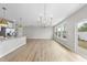 Kitchen and dining area boasts wood-look floors, modern lighting, and natural light at 100 Ripple Way # 317, Clayton, NC 27520