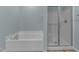 Well-lit bathroom featuring a shower and soaking tub at 10133 Bessborough Dr, Raleigh, NC 27617