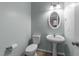 Cozy half bathroom features a pedestal sink and toilet at 10133 Bessborough Dr, Raleigh, NC 27617
