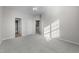 Spacious bedroom with a ceiling fan, neutral carpet, and multiple doorways at 10133 Bessborough Dr, Raleigh, NC 27617