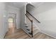 Bright entryway with wooden floors and staircase leading upstairs at 10133 Bessborough Dr, Raleigh, NC 27617