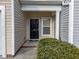Front door of townhome displaying address with small landscaped garden at 10133 Bessborough Dr, Raleigh, NC 27617