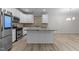 Modern kitchen with island and stainless steel appliances at 10133 Bessborough Dr, Raleigh, NC 27617