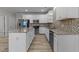 Modern kitchen featuring granite countertops and stainless steel appliances at 10133 Bessborough Dr, Raleigh, NC 27617