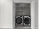 Laundry closet with a newer front-load washer and dryer set at 10133 Bessborough Dr, Raleigh, NC 27617