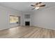 Bright living room with a fireplace, ceiling fan, and sliding door to the outside at 10133 Bessborough Dr, Raleigh, NC 27617