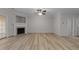 Bright living room with a fireplace, ceiling fan, and sliding door to the outside at 10133 Bessborough Dr, Raleigh, NC 27617