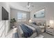 Cozy main bedroom features a ceiling fan, large bed, and a mounted television at 10133 Bessborough Dr, Raleigh, NC 27617