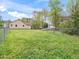 Spacious backyard featuring a large grassy area, chain link fence, and mature trees at 104 Black Cloud Dr, Louisburg, NC 27549