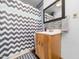 Bathroom showcasing a vanity with mirror and a bathtub with a white and grey zig-zag shower curtain at 104 Black Cloud Dr, Louisburg, NC 27549