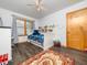 bedroom with bed, study space, hardwood floors, bright natural light, ceiling fan and door to hallway at 104 Black Cloud Dr, Louisburg, NC 27549