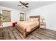Charming bedroom features warm wood flooring, bright natural light, ceiling fan and a wood bed frame at 104 Black Cloud Dr, Louisburg, NC 27549