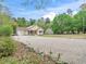 Charming home with a covered front porch, gravel driveway, well-manicured lawn and garage at 104 Black Cloud Dr, Louisburg, NC 27549