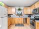 Bright kitchen featuring sleek stainless steel appliances, light wood cabinets, and a window over the sink at 104 Black Cloud Dr, Louisburg, NC 27549