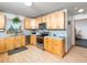Modern kitchen with stainless steel appliances, ample light wood cabinetry, and mosaic tile backsplash at 104 Black Cloud Dr, Louisburg, NC 27549