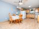 Eat-in kitchen with ceiling fan, wood cabinets, laminate floor, and stainless steel dishwasher at 104 Black Cloud Dr, Louisburg, NC 27549