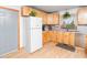 Well-lit kitchen with stainless steel appliances, light wood cabinets, and a gray door leading to another area at 104 Black Cloud Dr, Louisburg, NC 27549
