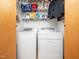 Laundry room featuring a washer and dryer with plenty of storage on the shelves above at 104 Black Cloud Dr, Louisburg, NC 27549