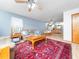 Inviting living space with plush leather sofas, an ornate rug, and a combined dining and kitchen area in background at 104 Black Cloud Dr, Louisburg, NC 27549