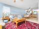 Warm living room with leather seating, an oriental rug, natural light, and an open floor plan to kitchen at 104 Black Cloud Dr, Louisburg, NC 27549