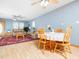 Comfortable living and dining area with hardwood floors, cozy seating, and a ceiling fan for added comfort at 104 Black Cloud Dr, Louisburg, NC 27549