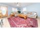 Cozy living room with leather sofas, an antique rug, and natural light streaming through the windows at 104 Black Cloud Dr, Louisburg, NC 27549