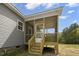 View of the screened-in back porch from the yard at 106 S Harper Faith Way, Benson, NC 27504