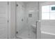 Luxurious bathroom showcasing tiled walk-in shower with built-in seat at 106 S Harper Faith Way, Benson, NC 27504