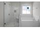 Bathroom featuring a stand alone tub and tiled walk-in shower at 106 S Harper Faith Way, Benson, NC 27504