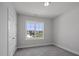 Bright bedroom with gray carpet, a window view, and fresh white paint at 106 S Harper Faith Way, Benson, NC 27504